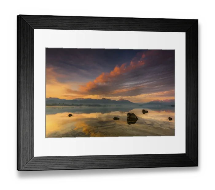 Framed Print : Forggensee with reflection of the cloudy sky and the Allgaeuer mountains in the background at sunrise Framed Print : Forggensee with reflection of the cloudy sky and the Allgaeuer mountains in the background at sunrise