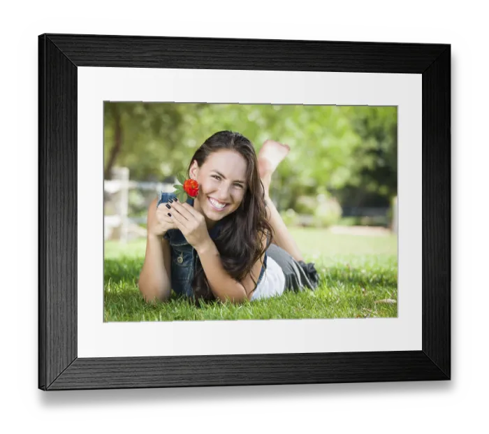 Framed Print : Attractive mixed-race girl portrait laying in grass outdoors with flower