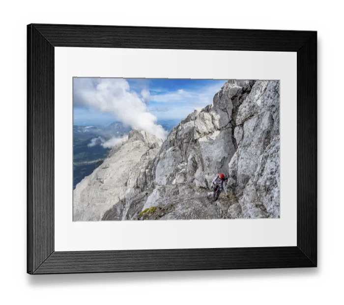 Framed Print : Mountaineer on a narrow rocky mountain path