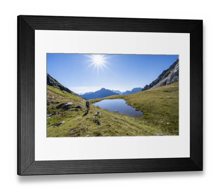 Framed Print : Mountaineer at a mountain lake