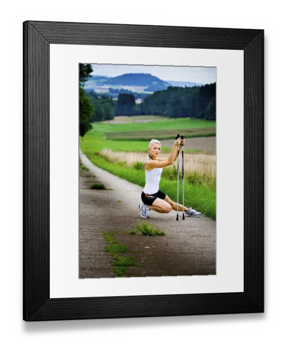 Framed Print : Young woman warming up for Nordic Walking