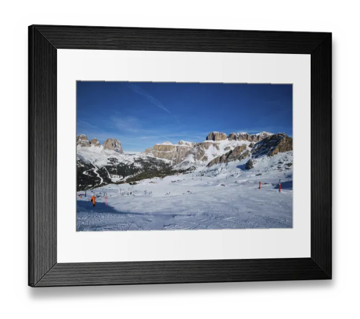 Framed Print : View of a ski resort piste with people skiing in Dolomites in Italy