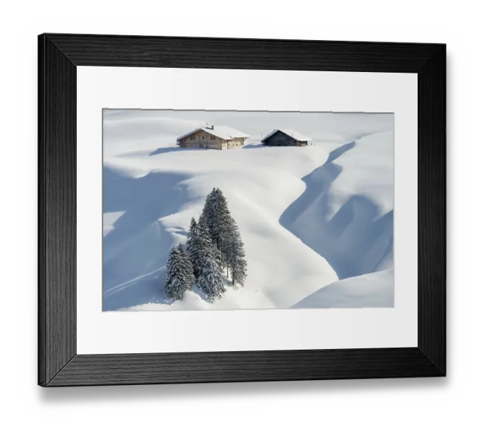 Framed Print : Freshly snow-covered winter landscape with an alp and trees in the Swiss mountains Framed Print : Freshly snow-covered winter landscape with an alp and trees in the Swiss mountains