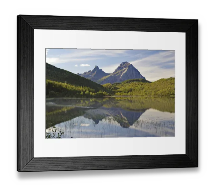 Framed Print : Striking mountains reflected in the calm waters of a small lake