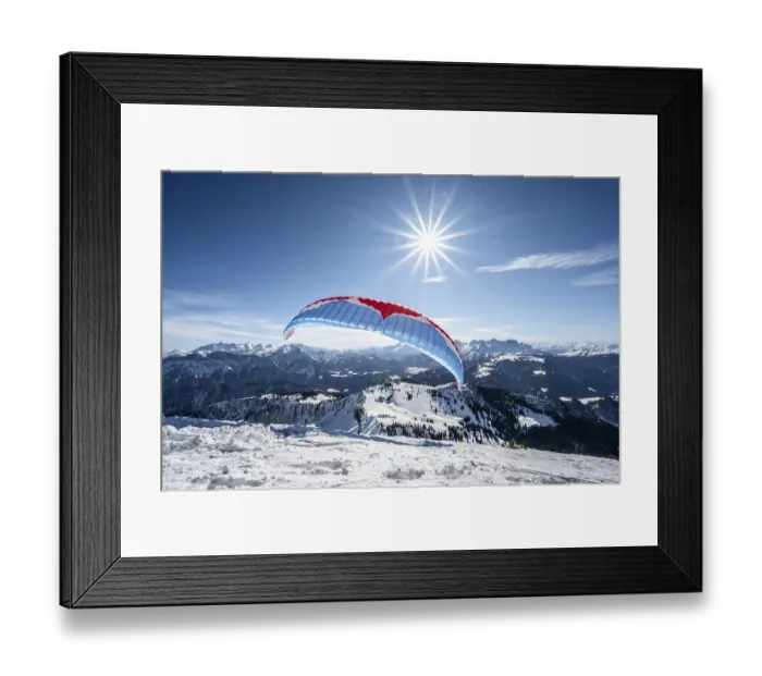 Framed Print : Paraglider at take-off in winter