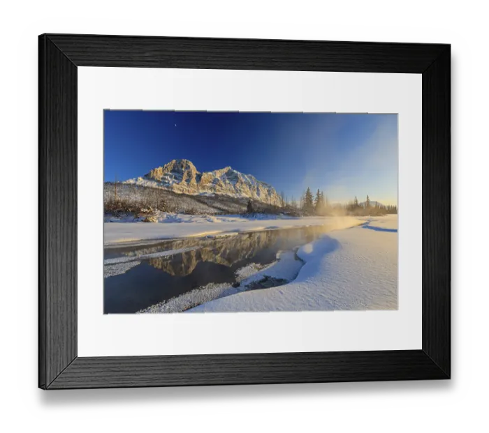 Framed Print : Snowy steep mountains reflected in frozen river