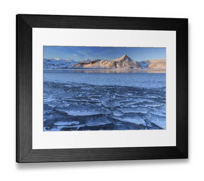 Framed Print : Ice floes on a lake in front of snowy mountains