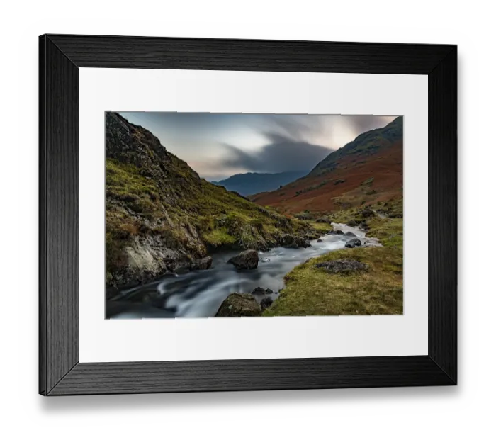 Framed Print : Brook run in autumnal hilly landscape with cloudy sky