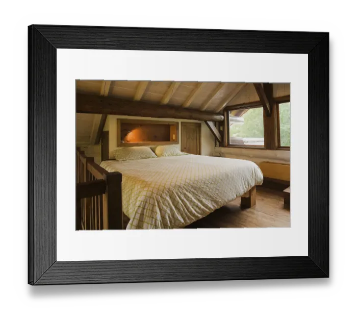 Framed Print : King size bed with wood frame in sparsely furnished Zen style master bedroom on mezzanine inside Scandinavian hybrid