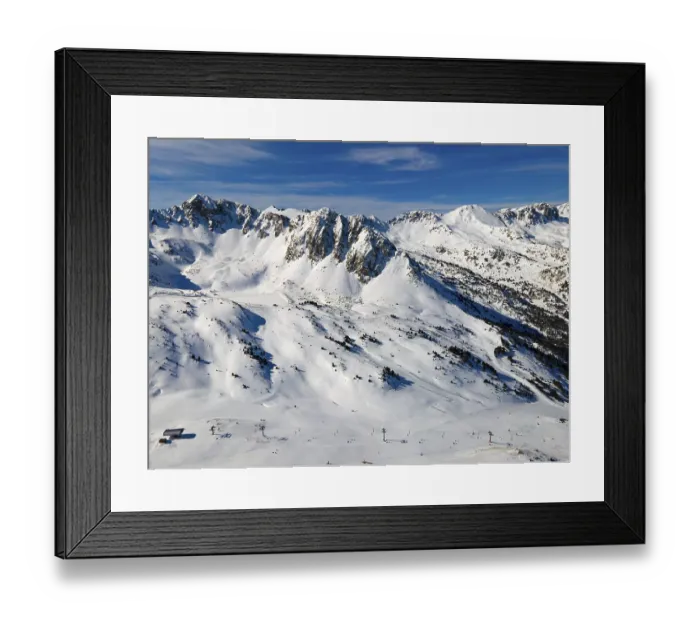 Framed Print : View of ski slopes in an alpine resort with snow-covered slopes