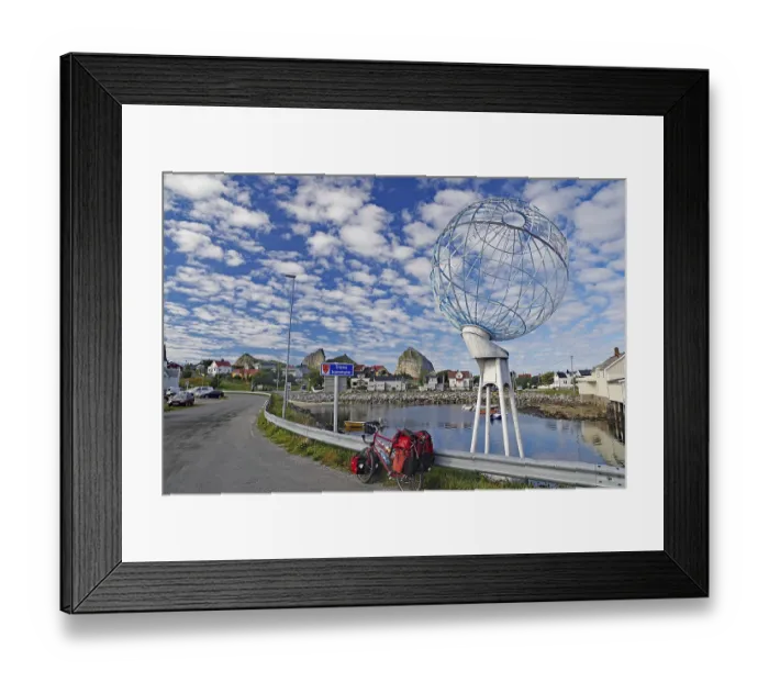 Framed Print : Packed touring bike in front of a huge globe and a harbour
