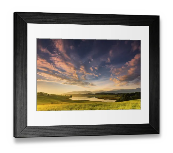 Framed Print : Forggensee with mountain meadow and the Allgaeuer mountains in the background at sunrise