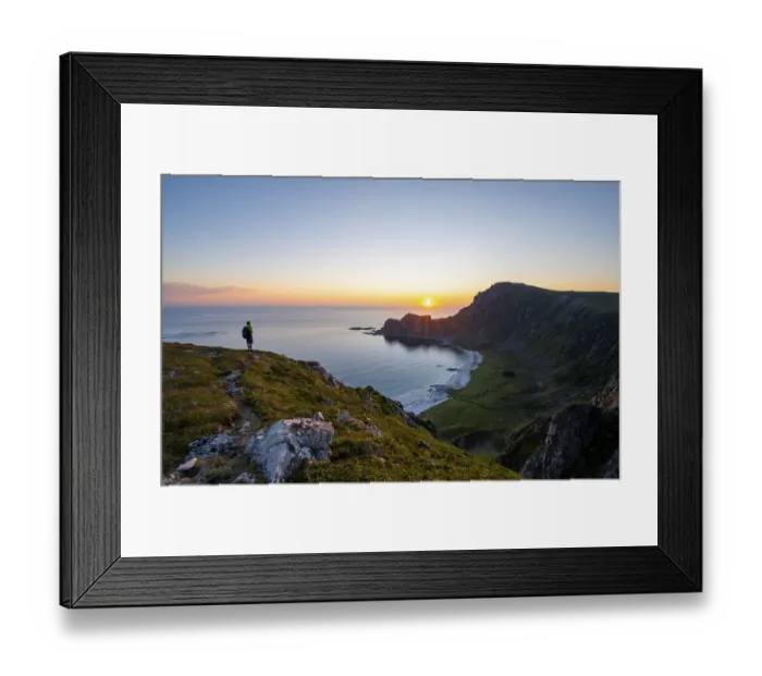 Framed Print : Mountaineer in front of view of coastal landscape at sunset Framed Print : Mountaineer in front of view of coastal landscape at sunset