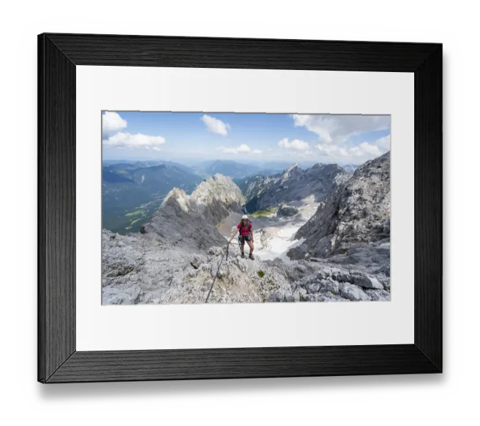 Framed Print : Mountaineer with helmet in a secured via ferrata Framed Print : Mountaineer with helmet in a secured via ferrata
