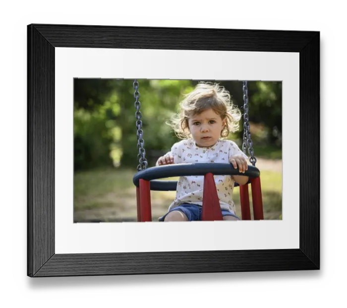 Framed Print : Child, 2 years, swings outdoors in a playground with a sunny atmosphere