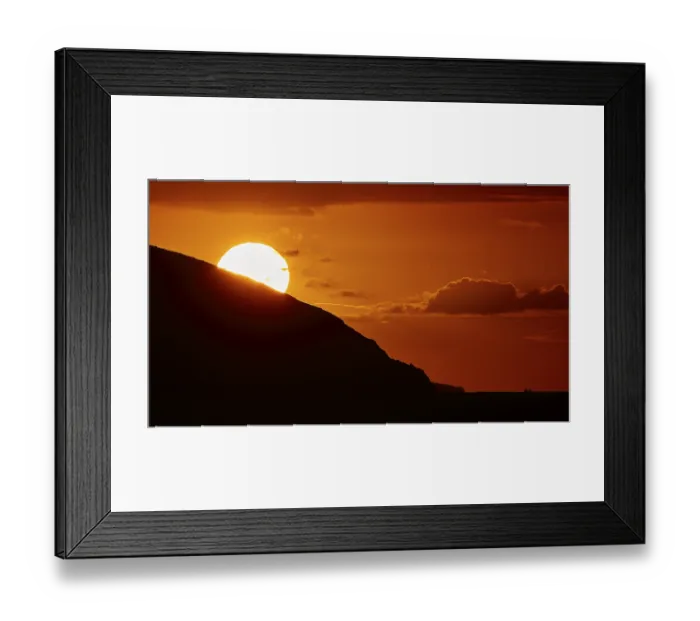 Framed Print : Sun disappears behind mountain