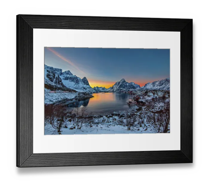 Framed Print : Sunset casting warm hues over a tranquil fjord surrounded by snow-covered mountains