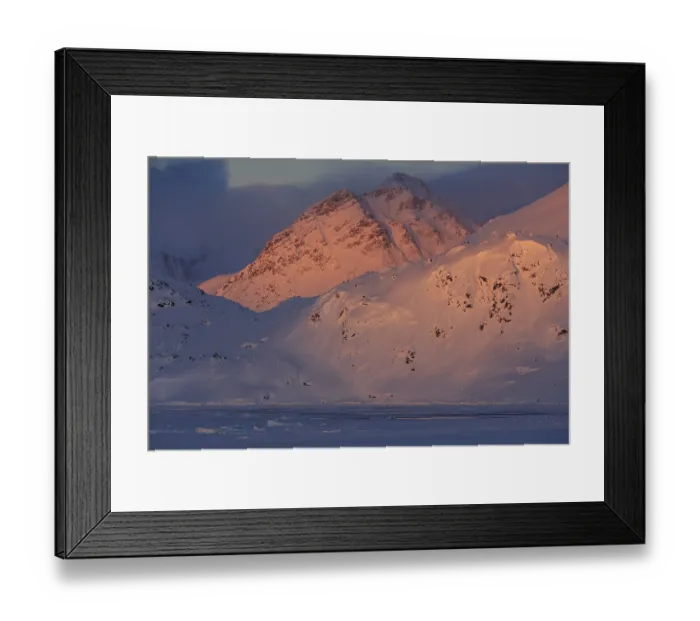 Framed Print : Evening light on snowy mountains