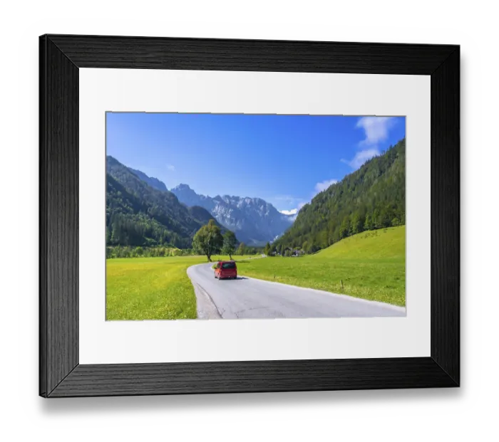Framed Print : Red van driving along a winding road in the picturesque logarska dolina valley