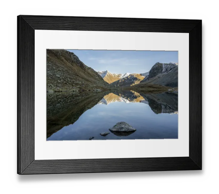 Framed Print : Slightly snow-covered mountains reflected in Schwarzsee in autumn on the Flueela Pass