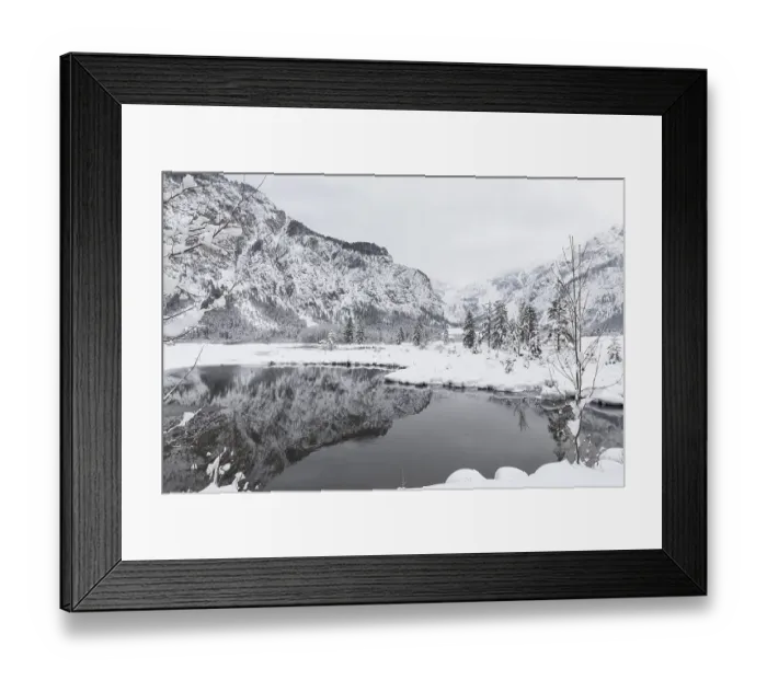 Framed Print : Snow covered Lake Almsee which is partly frozen and snow covered