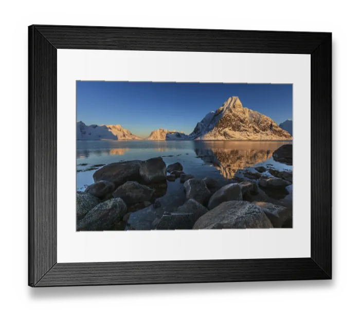 Framed Print : Snow-covered mountains reflected in the fjord at sunrise