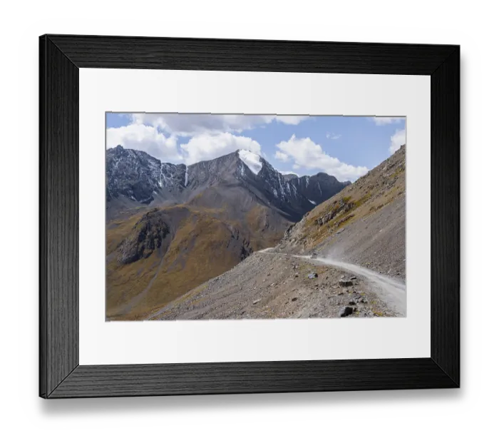 Framed Print : Narrow gravel track in mountain landscape at Chong Ashuu Pass Framed Print : Narrow gravel track in mountain landscape at Chong Ashuu Pass