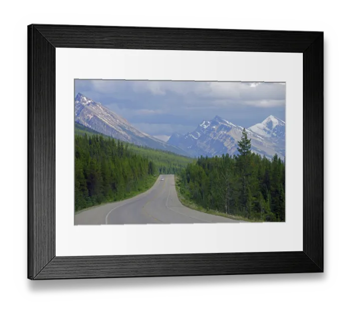 Framed Print : Wide, deserted road leads through a wild mountain landscape Framed Print : Wide, deserted road leads through a wild mountain landscape