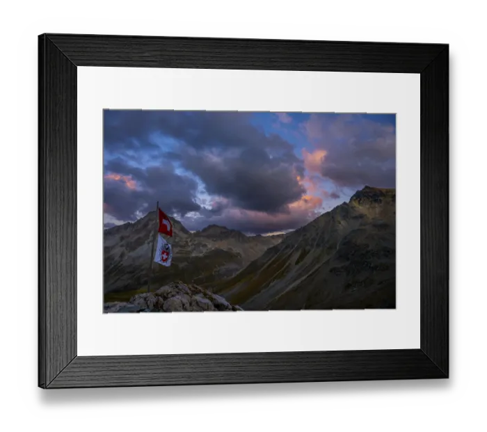 Framed Print : Swiss flag and flag of the SAC with cloudy sky at blue hour and Engadine mountains