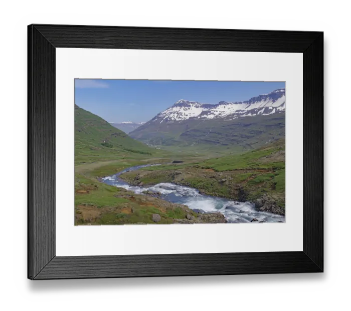 Framed Print : Water falls into a deeply incised valley framed by high mountains