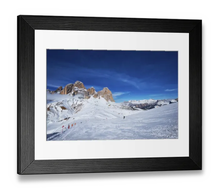 Framed Print : View of a ski resort piste with people skiing in Dolomites in Italy Framed Print : View of a ski resort piste with people skiing in Dolomites in Italy