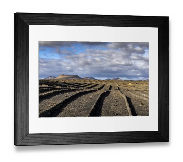 Framed Print : Volcanic crater, The stony terraces of volcanic soil stretch out under a dramatic Framed Print : Volcanic crater, The stony terraces of volcanic soil stretch out under a dramatic