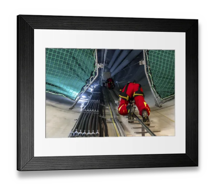 Framed Print : Height rescuers from the Oberhausen professional fire brigade practise abseiling from a wind turbine from a height of