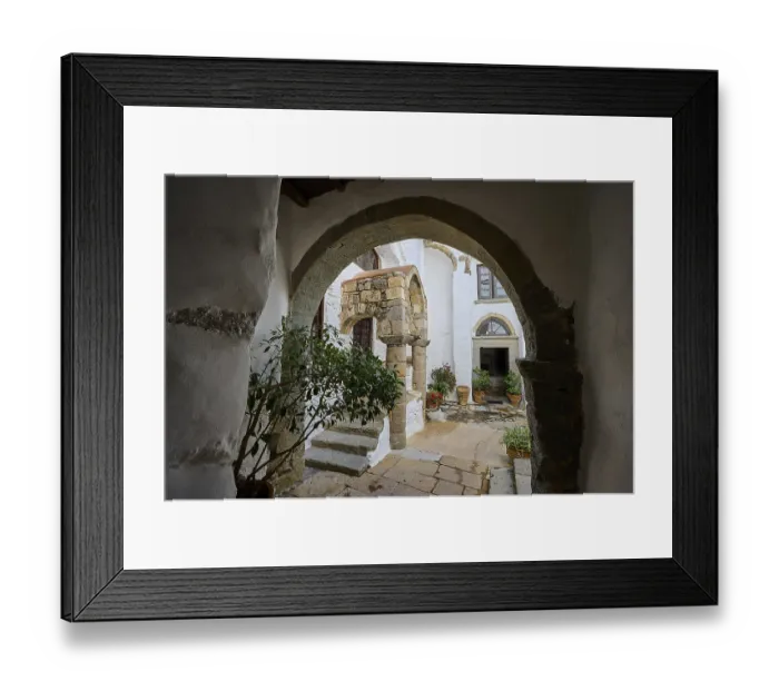 Framed Print : Historic courtyard of a monastery with stone arches and Mediterranean architecture