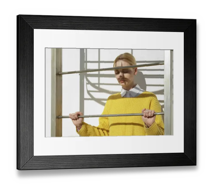 Framed Print : Girl in white shirt sticking out under yellow sweater and blue jeans posing near fire escape