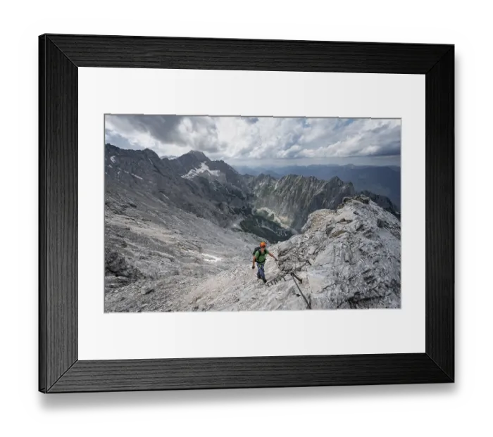Framed Print : Mountaineer with helmet climbing on rock