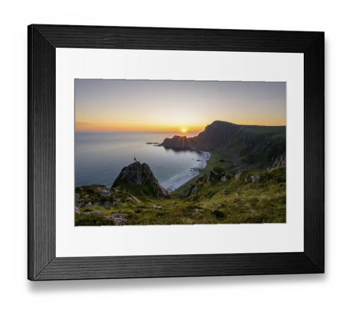 Framed Print : Climber on rocks in front of picturesque landscape