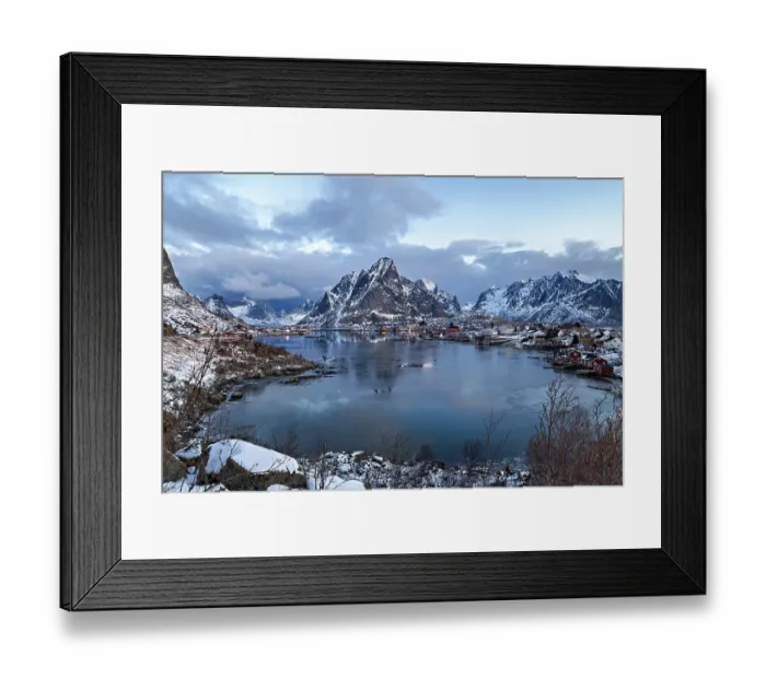 Framed Print : Twilight over a snowy village in Lofoten with calm waters and mountain backdrop Framed Print : Twilight over a snowy village in Lofoten with calm waters and mountain backdrop