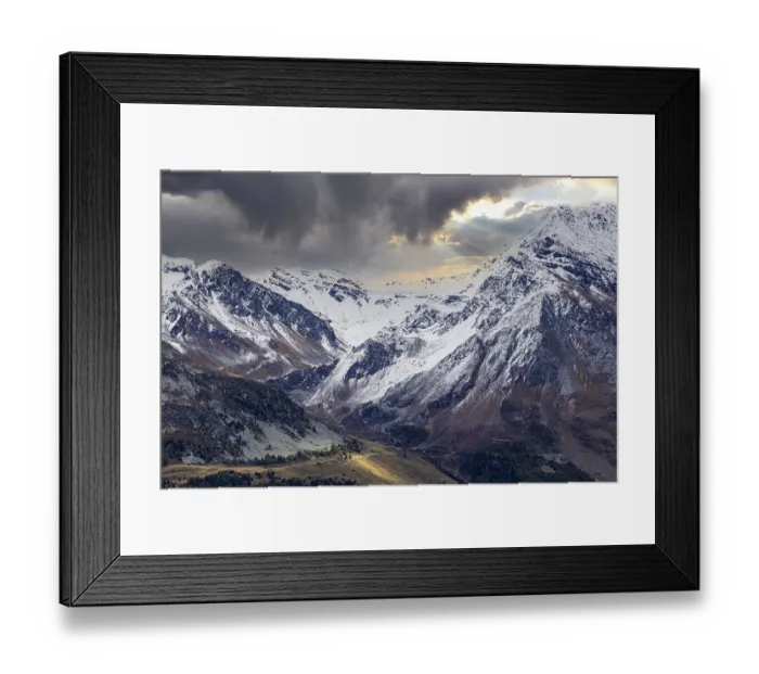 Framed Print : Dark clouds over the snow-covered mountains above Saint Luc