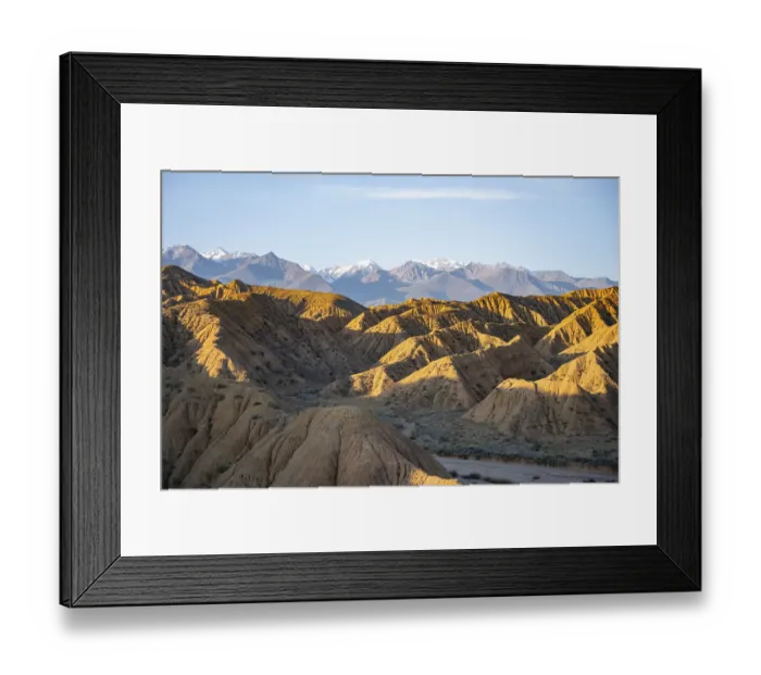 Framed Print : Landscape of eroded hills at sunrise