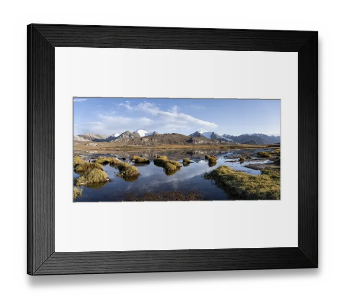 Framed Print : Glaciated mountain peaks reflected in a mountain lake at sunset
