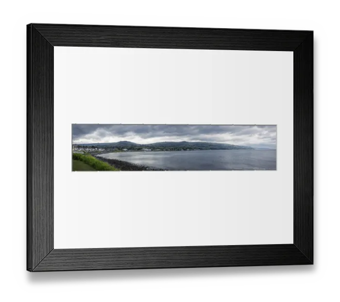 Framed Print : Coastal panorama with mountains in the background and cloudy sky Framed Print : Coastal panorama with mountains in the background and cloudy sky