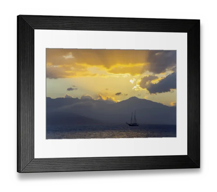 Framed Print : A sailboat on the sea in front of a dramatic sunset