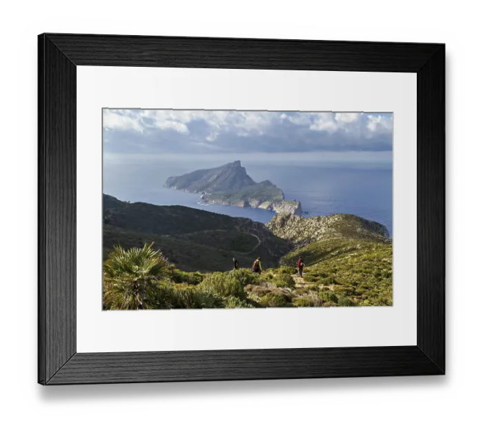Framed Print : Two hikers on a mountain trail with panoramic views of the sea and surrounding greenery