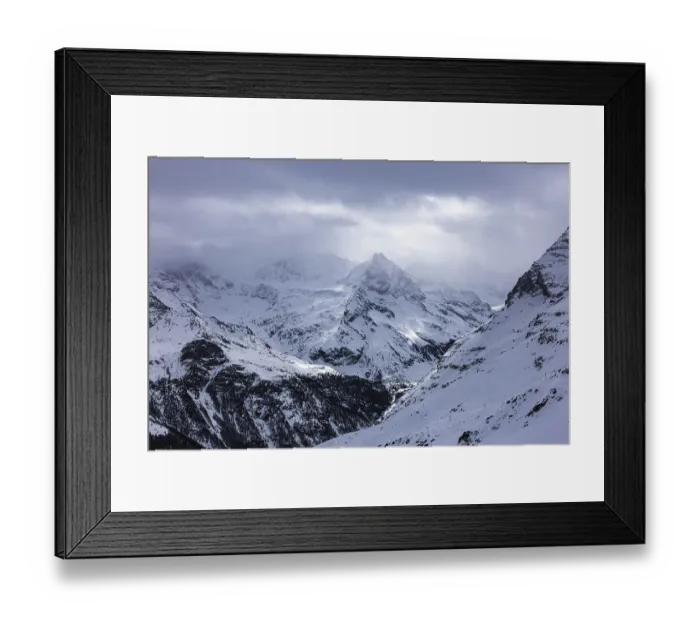 Framed Print : Dark clouds and wafts of mist surround the snow-covered summit of Mount Le Besso Framed Print : Dark clouds and wafts of mist surround the snow-covered summit of Mount Le Besso