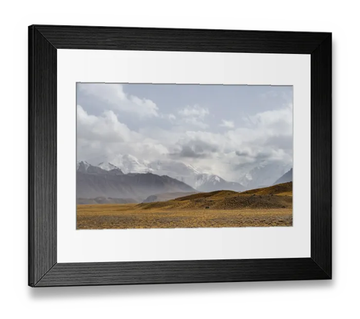 Framed Print : Glaciated, cloud-covered mountain peaks and golden meadows Framed Print : Glaciated, cloud-covered mountain peaks and golden meadows