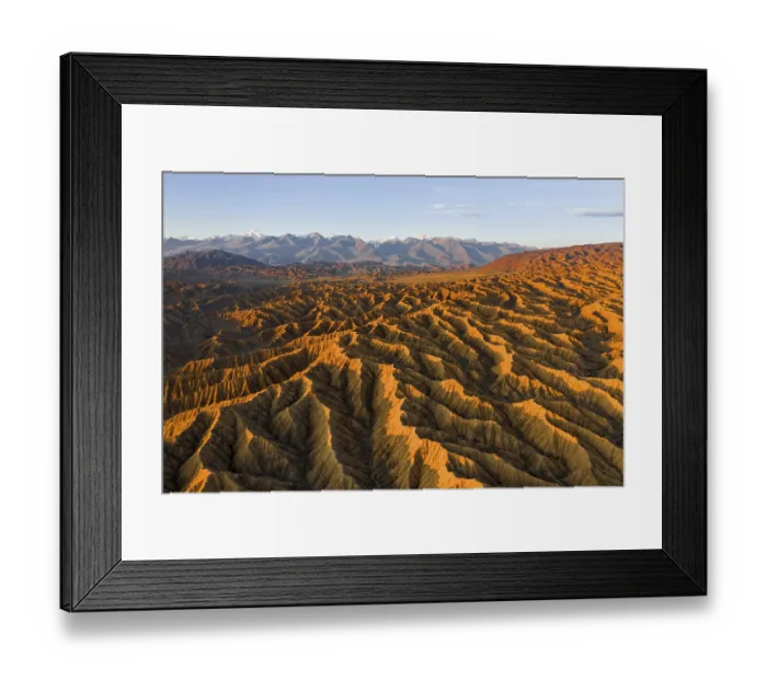 Framed Print : Landscape of eroded hills, badlands at sunset