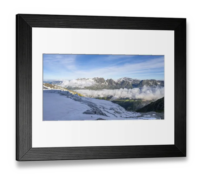 Framed Print : View of mountain peaks and the valley of Chamonix with high fog