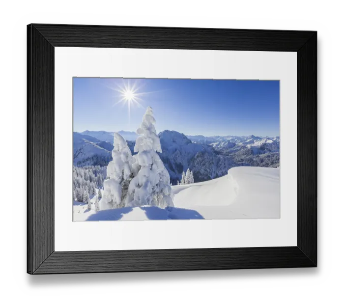 Framed Print : Winter landscape and snow-covered trees in front of mountains