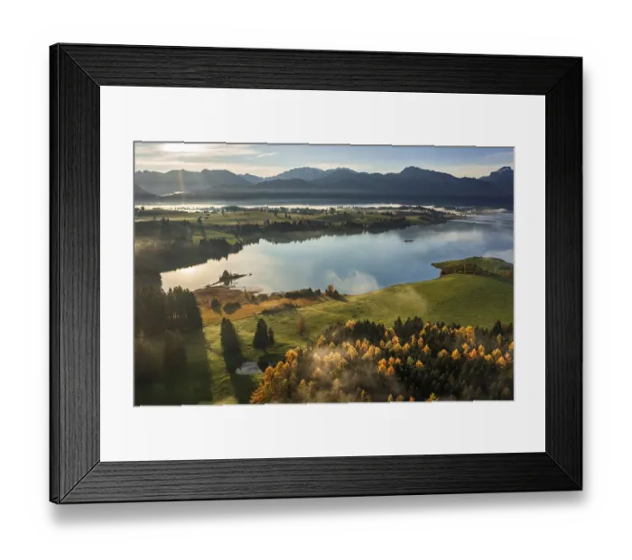 Framed Print : Aerial view of a lake in front of mountains in the morning light